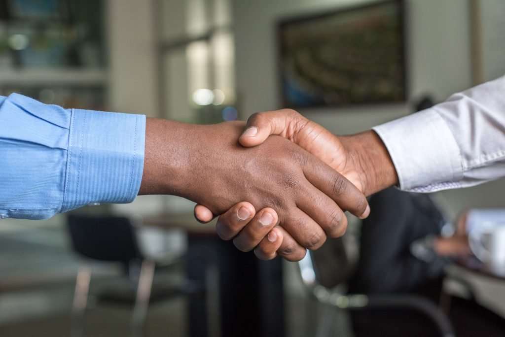 Rejecting candidates; two people shake hands