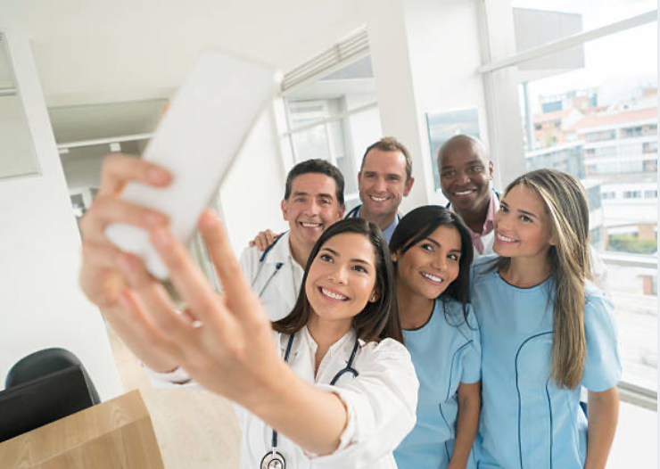 Differences between social media platforms; a group of physicians and nurses take a selfie using a smartphone