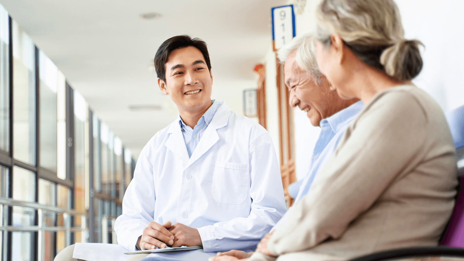 Doctor speaking with two elderly patients