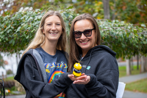 rater8 employees pose with the company's bumblebee mascot