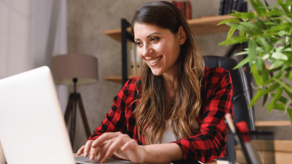 Happy remote employee working on a laptop